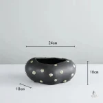 Vase noir et or, une pièce maîtresse pour la maison