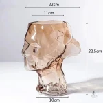 Vase haut en verre avec design visage stylisé
